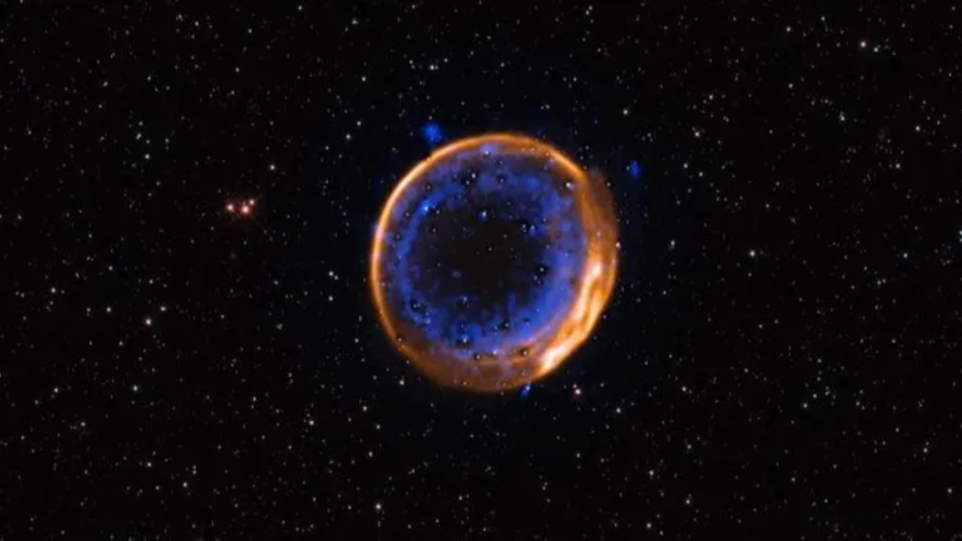 SNR 0509-67.5, kalsium ditampilkan dalam warna biru, dan muncul dalam dua cangkang konsentris yang menunjukkan adanya ledakan ganda(credit: ESO/P. Das et al. Background stars (Hubble): K. Noll et al)