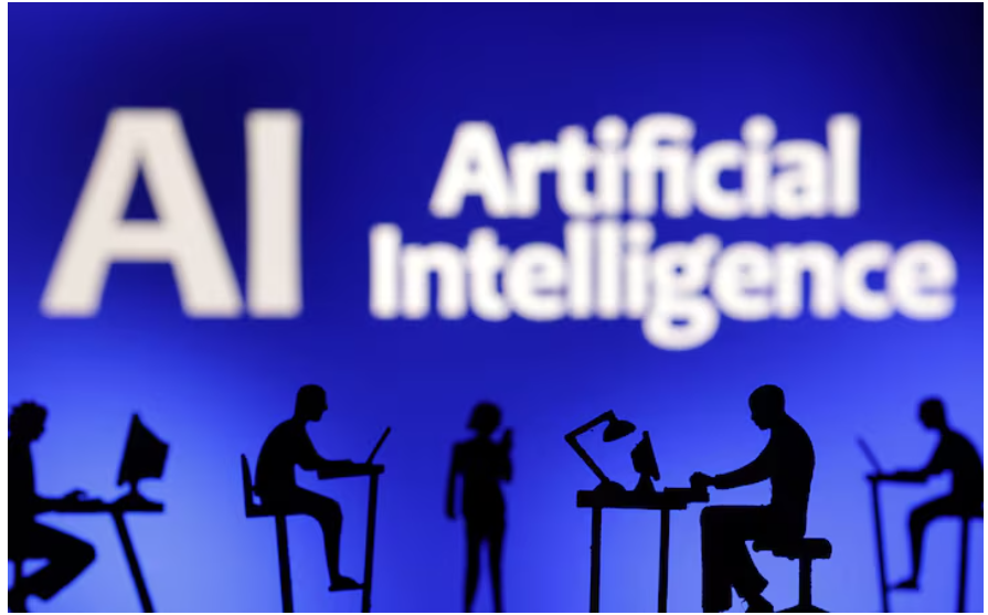 Figurines with computers and smartphones are seen in front of the words "Artificial Intelligence AI"