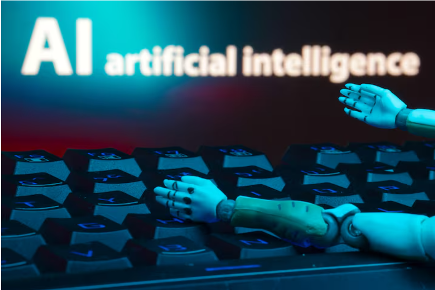 A message reading "AI artificial intelligence", a keyboard, and robot hands are seen in this illustration taken January 27, 2025.
