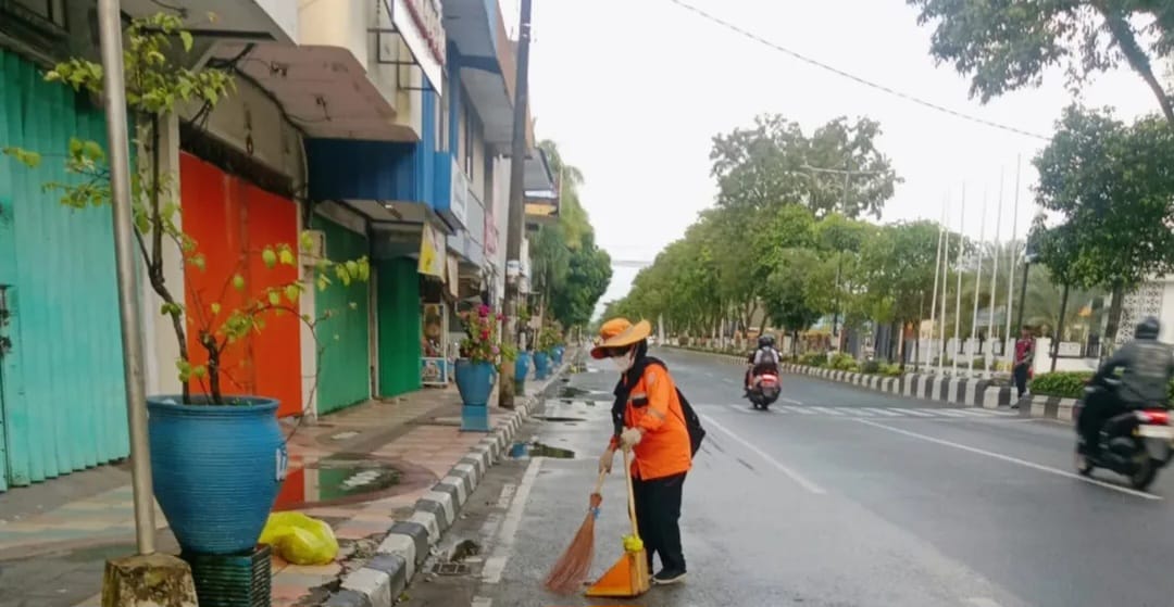 RISIKO TINGGI: Ilustrasi petugas kebersihan menyapu ruas jalan di kawasan Jl. Jend Sudirman Balikpapan. Bersinggungan langsung dengan lalu lalang kendaraan. FOTO: ISTIMEWA