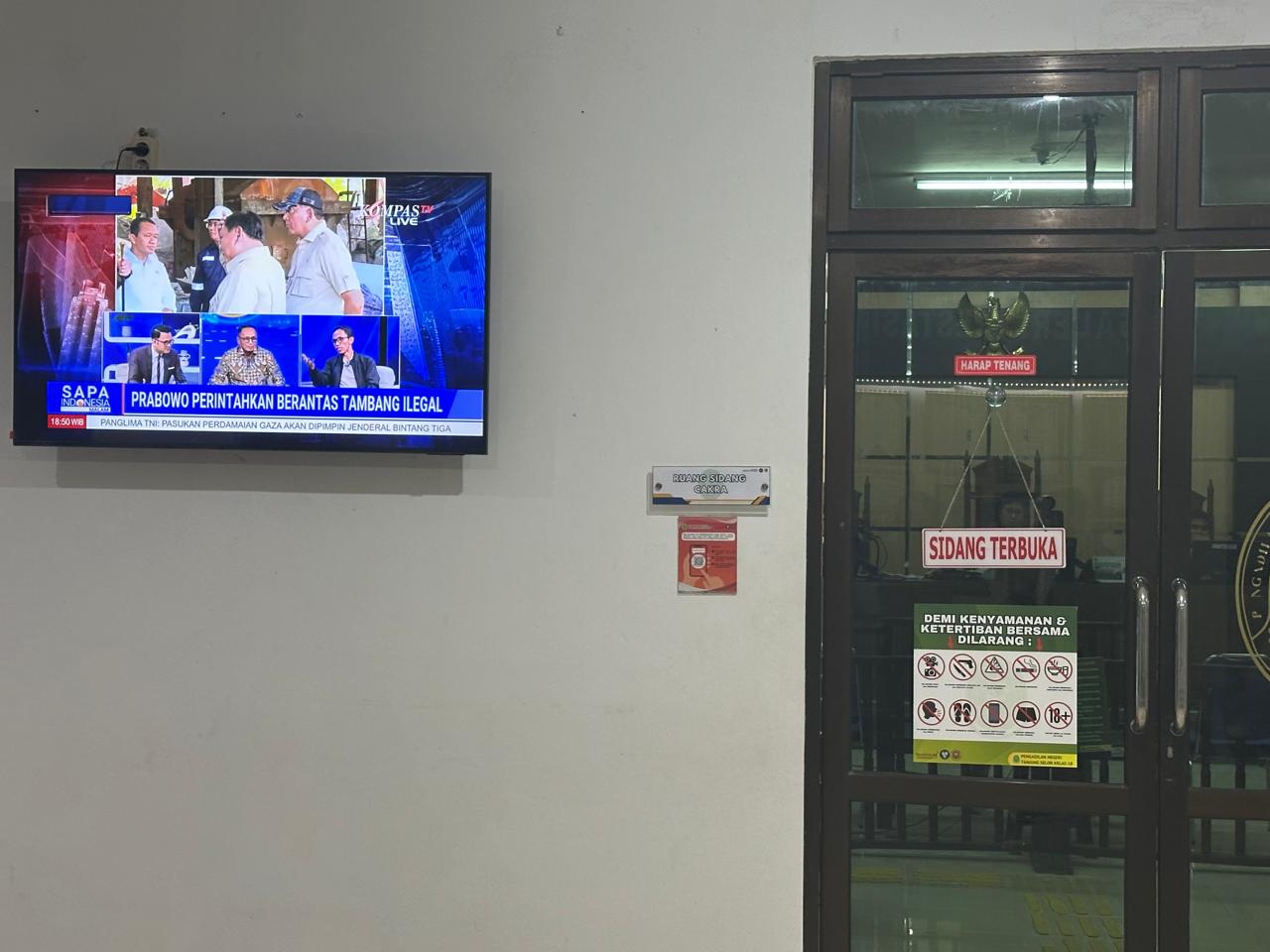 SIDANG : Sebuah televisi yang terpasang di dinding menayangkan siaran berita nasional yang membahas instruksi pemberantasan tambang ilegal