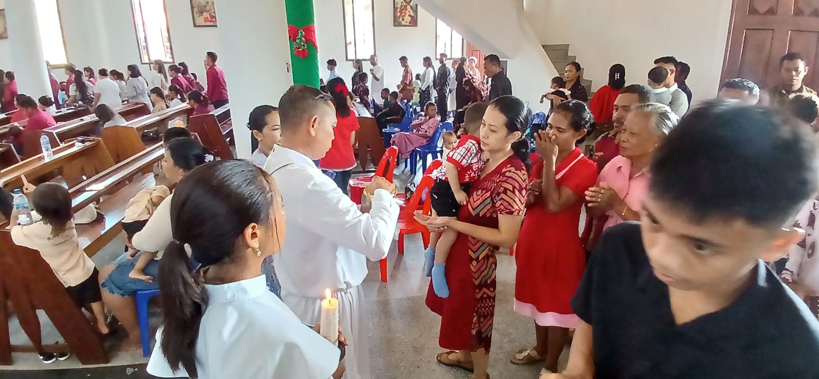 BERKAT : Jemaat Gereja Paroki Santa Maria Imakulata menerima berkat dari romo gereja.
