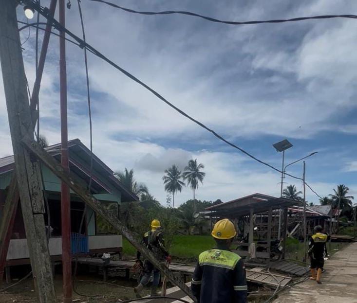 &lrm;SIAP MENYALA: Pekerja PLN memasang jaringan listrik di Desa Sengkong, Kecamatan Sesayap Hilir.