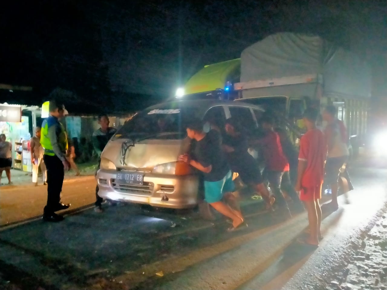 Warga membantu mengevakusi kendaraan yang terlibat kecelakaan beruntun diJalinsum Medan-Rantau Prapat KM 163-164.