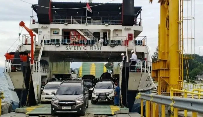 Kendaraan roda empat keluar dari kapal penyeberangan di Danau Toba.