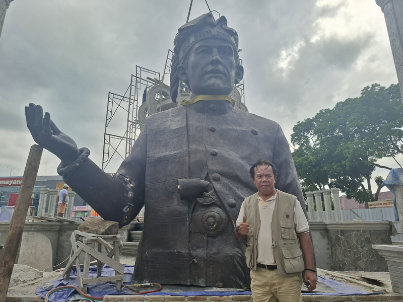 Humas Pembangunan Tugu Sangnawaluh H Sahat Silalahi dengan latar patung yang baru tiba di Kota Siantar.