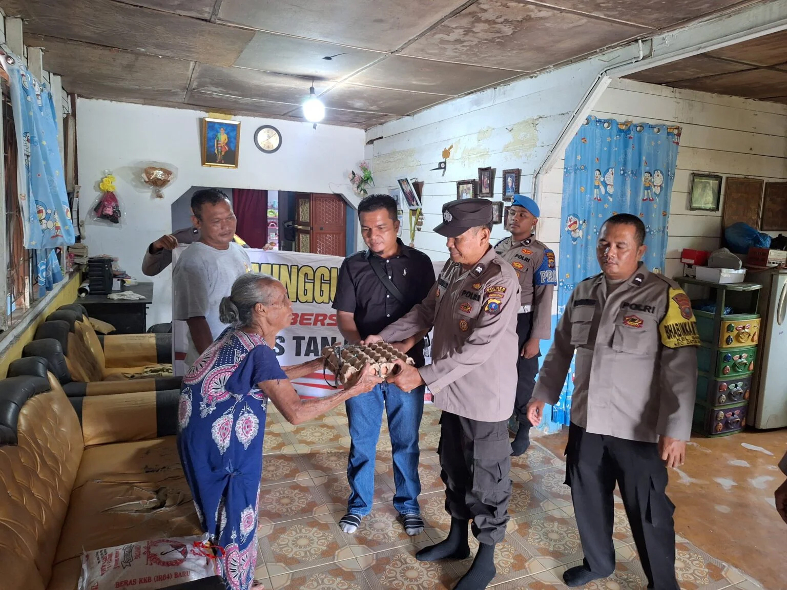 Penyerahan bantuan Polres Tanjungbalai kepada warga dalam Program Minggu Kasih.