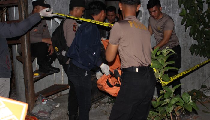 Petugas Polres Samosir mengevakuasi jasad korban dari dalam tugu.