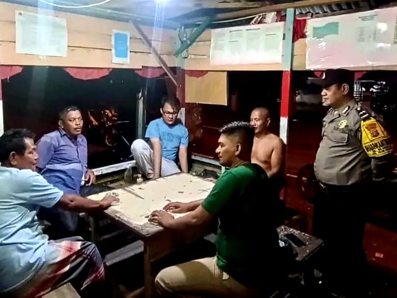 Bhabinkamtibmas Kelurahan Sei Merbau, Aipda TC Panjaitan bersama warga saat ronda malam di Pos Kamling.