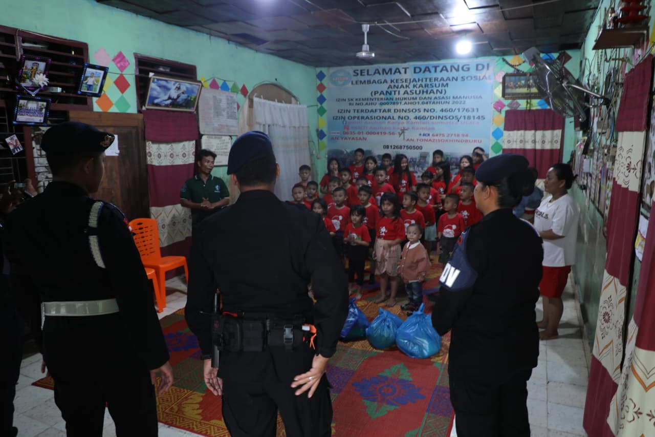 Personel Brimob Polda Sumut saat berbagi sembako kepada anak-anak panti asuhan dan warga kurang mampu di Medan.