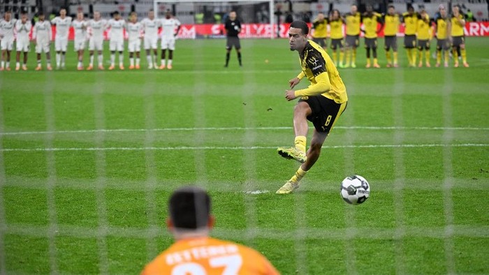Pemain Borussia Dortmund mencetak gol ke gawang Eintracht Frankfurt lewat adu penalti di DFB Pokal.