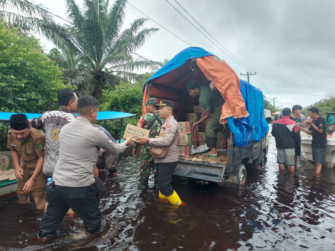 Personel Polda Sumut menyalurkan bantuan sembako kepada warga terdampak di titik lokasi banjir dan longsor.