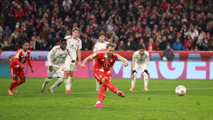 Harry Kane merayakan gol penalti ke gawang Mainz 05 yang menyelamatkan Bayern Munich dari kekalahan di Allianz Arena.