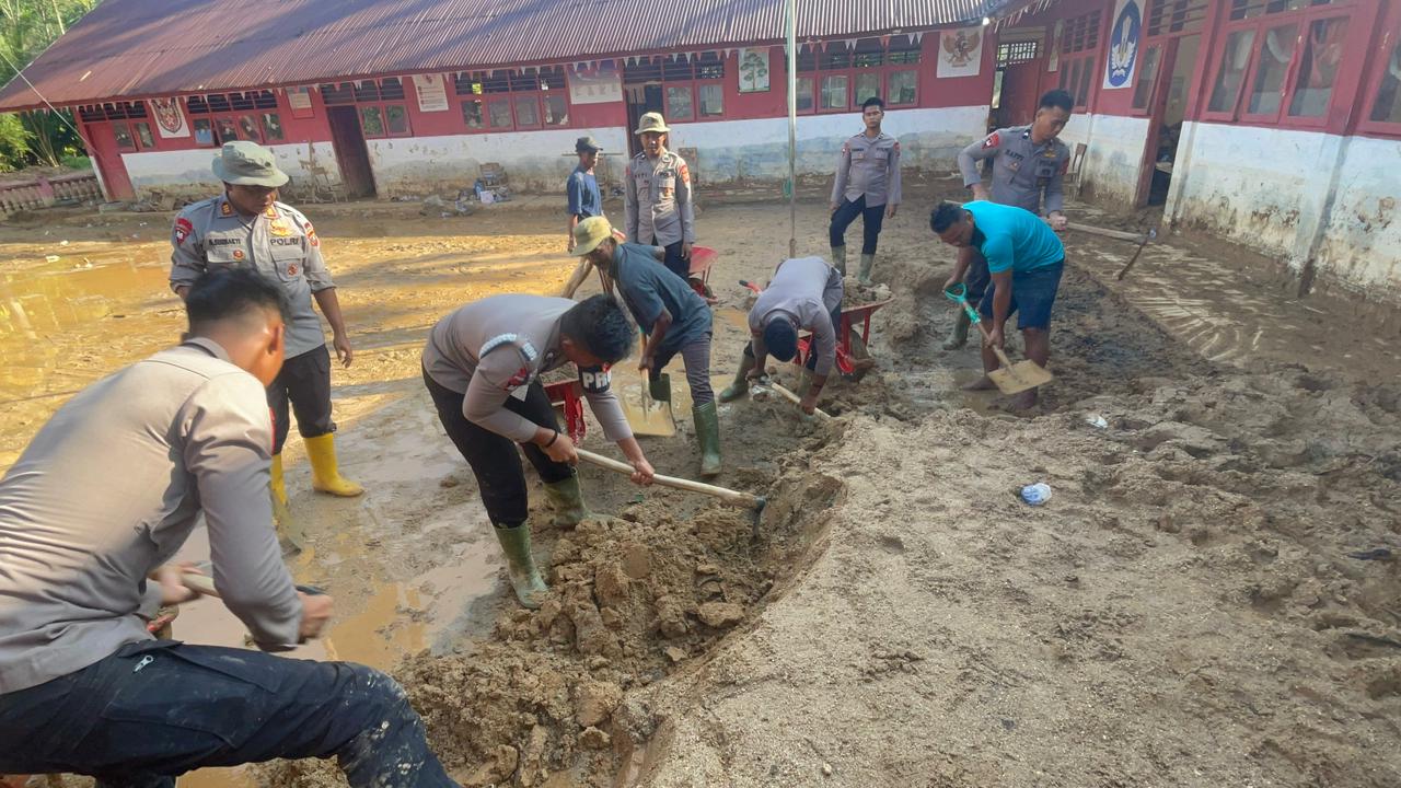 Personel Brimob Polda Sumut bersama guru dan warga membersihkan ruang kelas sekolah terdampak bencana di Kecamatan Tukka, Kabupaten Tapanuli Tengah.