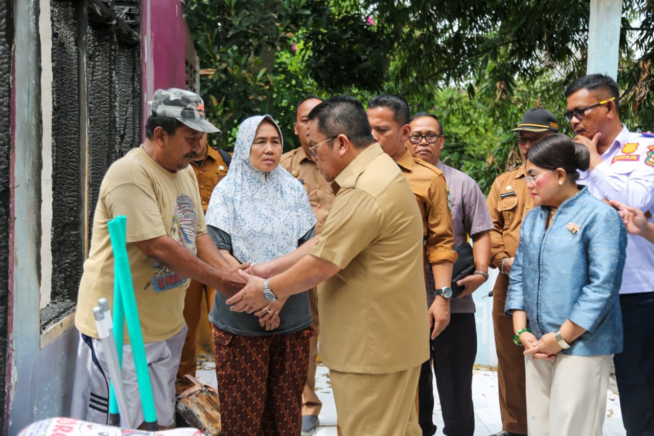 Wali Kota Pematangsiantar Wesly Silalahi didampingi Ketua TP PKK Liswati Wesly Silalahi menyerahkan bantuan kepada korban kebakaran rumah di Jalan Kasuari, Siantar Barat.