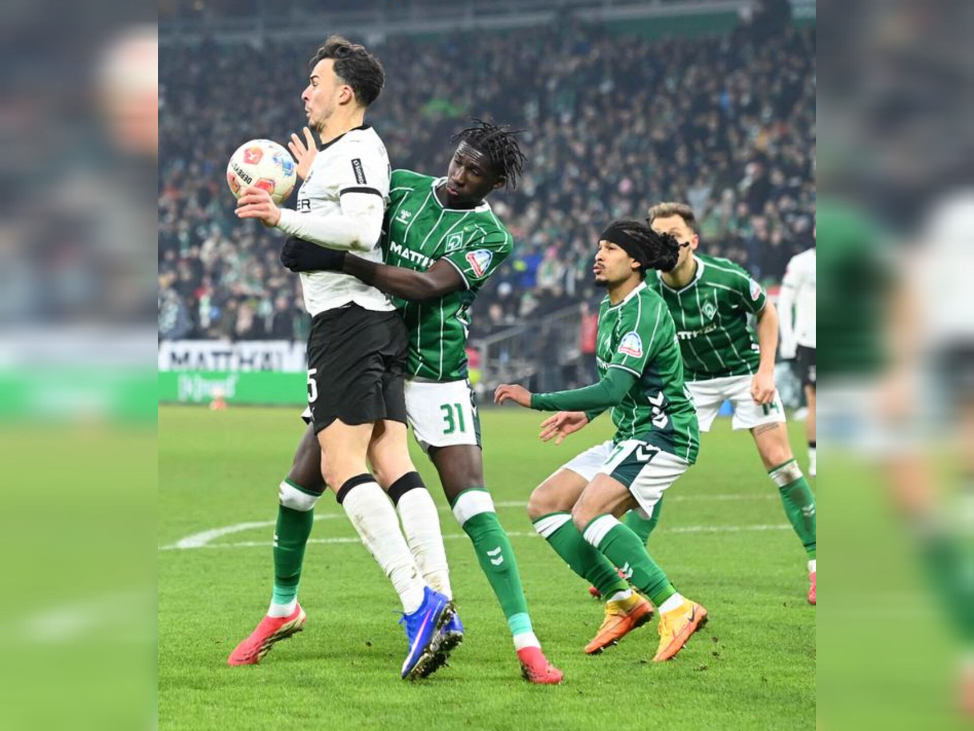 Pemain Borussia Moenchengladbach berusaha menahan serangan Werder Bremen dalam laga Bundesliga di Weserstadion yang berakhir imbang 1-1.
