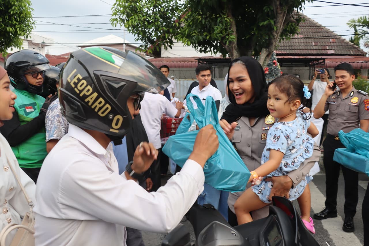 Kapolres Pematangsiantar AKBP Sah Udur Togi Marito Sitinjak bersama jajaran membagikan takjil kepada pengguna jalan di Jalan Sutomo, Senin (2/3). 
