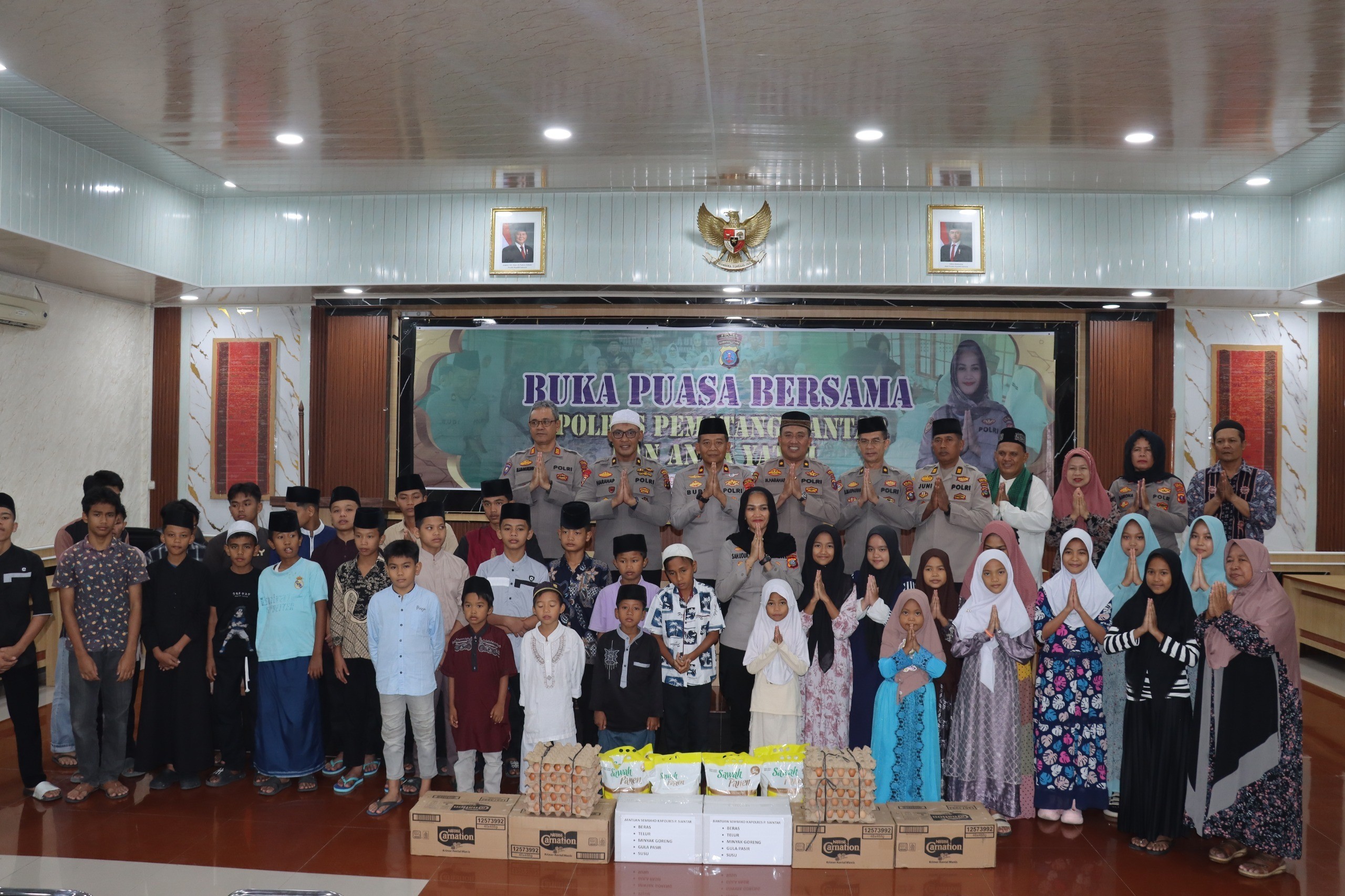 Kapolres Pematangsiantar AKBP Sah Udur Togi Marito Sitinjak bersama jajaran menyerahkan bantuan kepada anak yatim saat buka puasa bersama di Mapolres Pematangsiantar. 