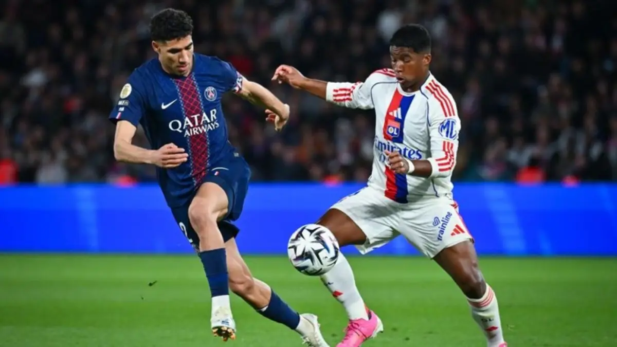 Pemain Olympique Lyonnais dan pemain Paris Saint-Germain berebut bola dalam laga Ligue 1 di Parc des Princes, yang berakhir kemenangan 2-1 untuk Lyon.
