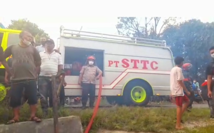 Petugas Damkar PT STTC turut membantu memadamkan api di Jalan Bah Binomon.