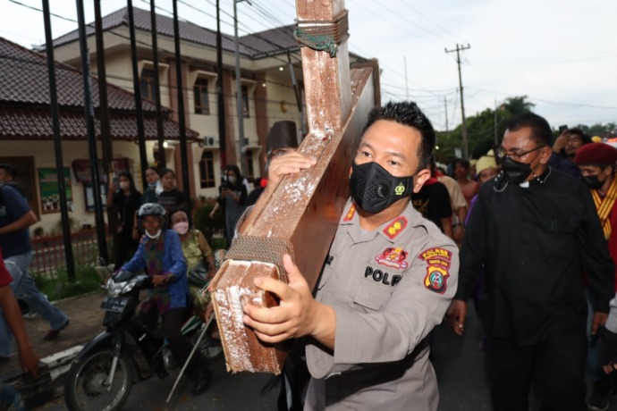 Kapolres Siantar, AKBP Boy Siregar saat mengangkat salib. (Foto: Matius Gea/Metro Siantar)