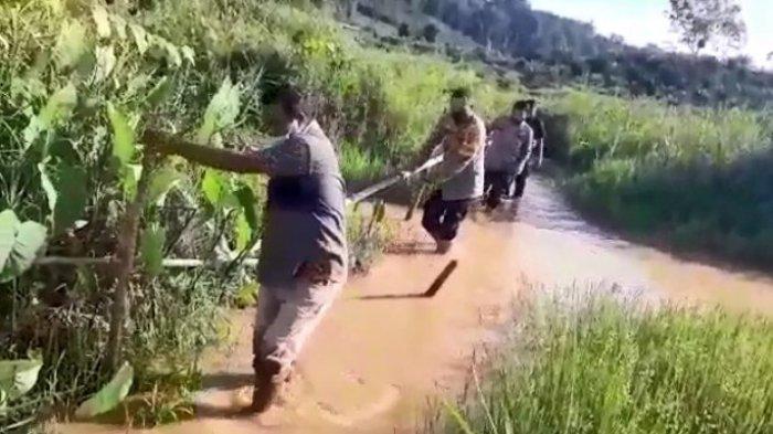 Kapolres Madina AKBP M Reza Chairul Akbar menembus sungai kecil dan lumpur ke TKP tambang emas longsor.