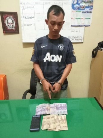Tersangka kasus judi togel dan barang bukti.