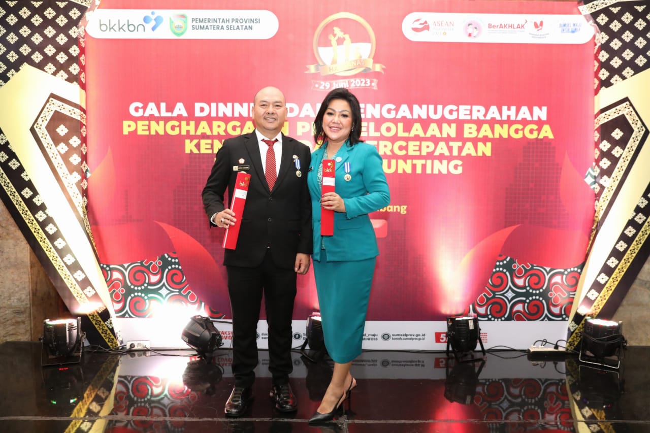 Bupati Taput Nikson Nababan dan istri Satika Simamora saat menerima penghargaan.