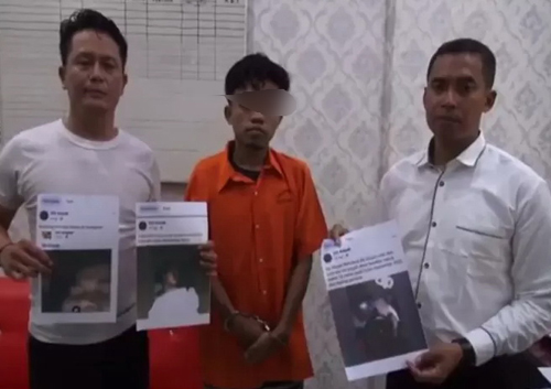 Tersangka (tengah) penyebar video porno.