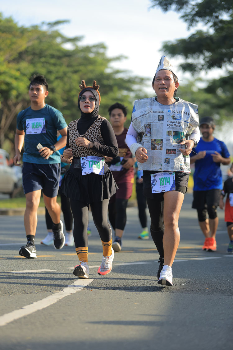 Selain tampil sporty, peserta lari juga mengenakan kostum unik dengan bahan koran. FUAD MUHAMMAD/KALTIM POST
