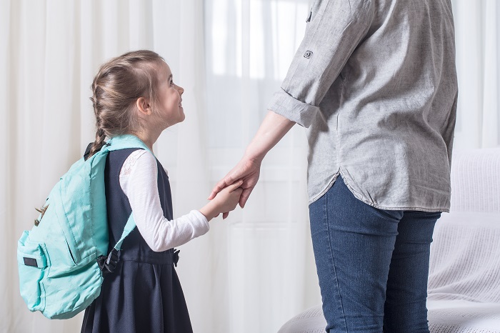 Ilustrasi seorang anak perempuan yang memakai tas ransel dengan bantalan tebal dan nyaman di bagian punggung. Tali bahu yang lebar dan empuk membantu mengurangi tekanan pada bahu anak.