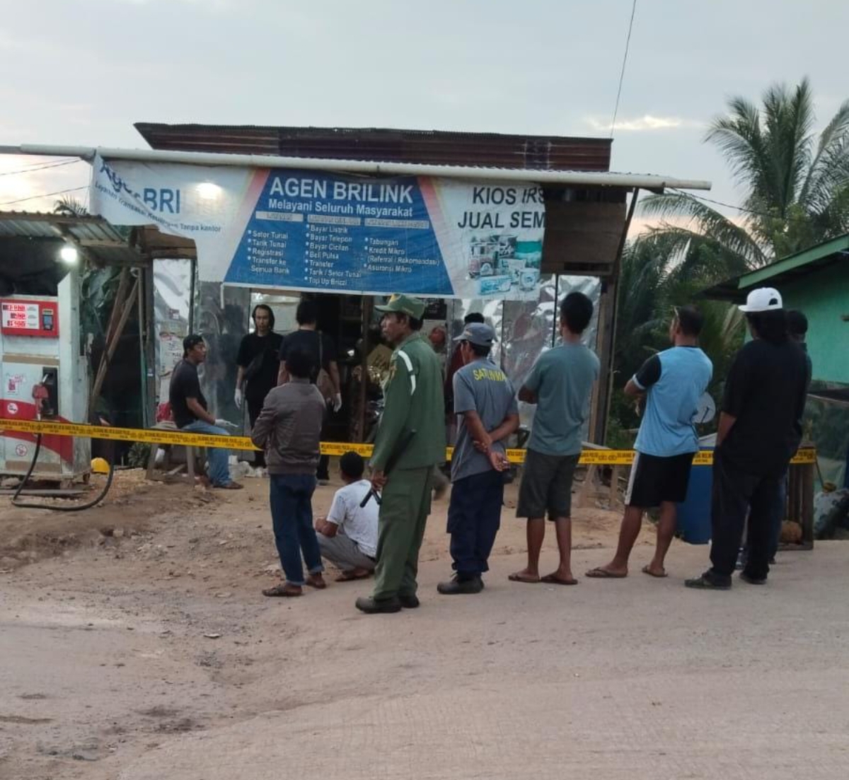 SADIS: Warga ber kerumun di depan lokasi perampokan dan pembunuhan di Kaubun, Kutai Timur. (FOTO: IST)