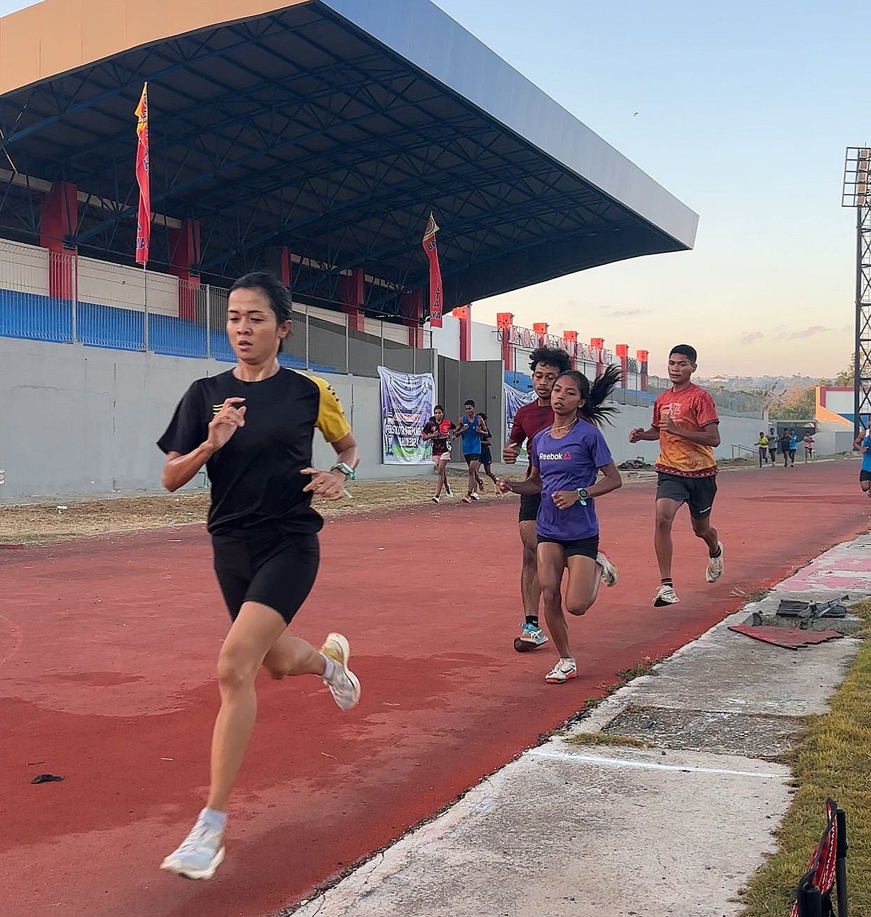 MATANGKAN PERSIAPAN: Irma Handayani (kaos hitam) melakukan latihan di lintasan lari Stadion Oepoi, Kupang NTT. (FOTO: IST)