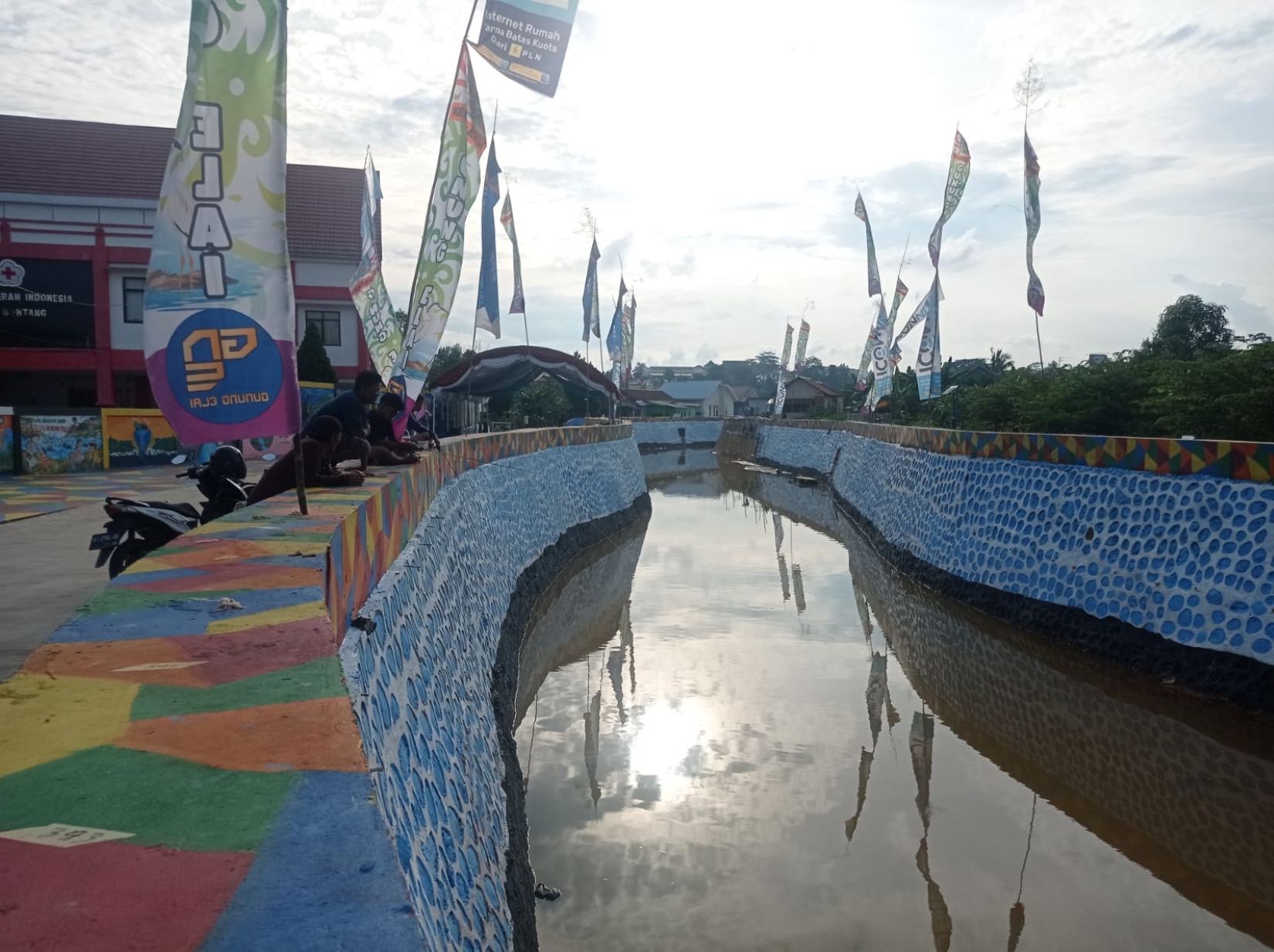 WARNA-WARNI: Panorama yang tersaji dari turap sungai di samping Kantor PMI Bontang yang dipenuhi perpaduan warna menarik. Pelaku UMKM akan menjual produknya di lokasi ini pada sore hari.