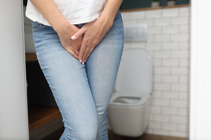 Ilustrasi seseorang yang kehilangan kontrol terhadap kandung kemih, yang mengakibatkan keluarnya urine secara tidak sengaja.