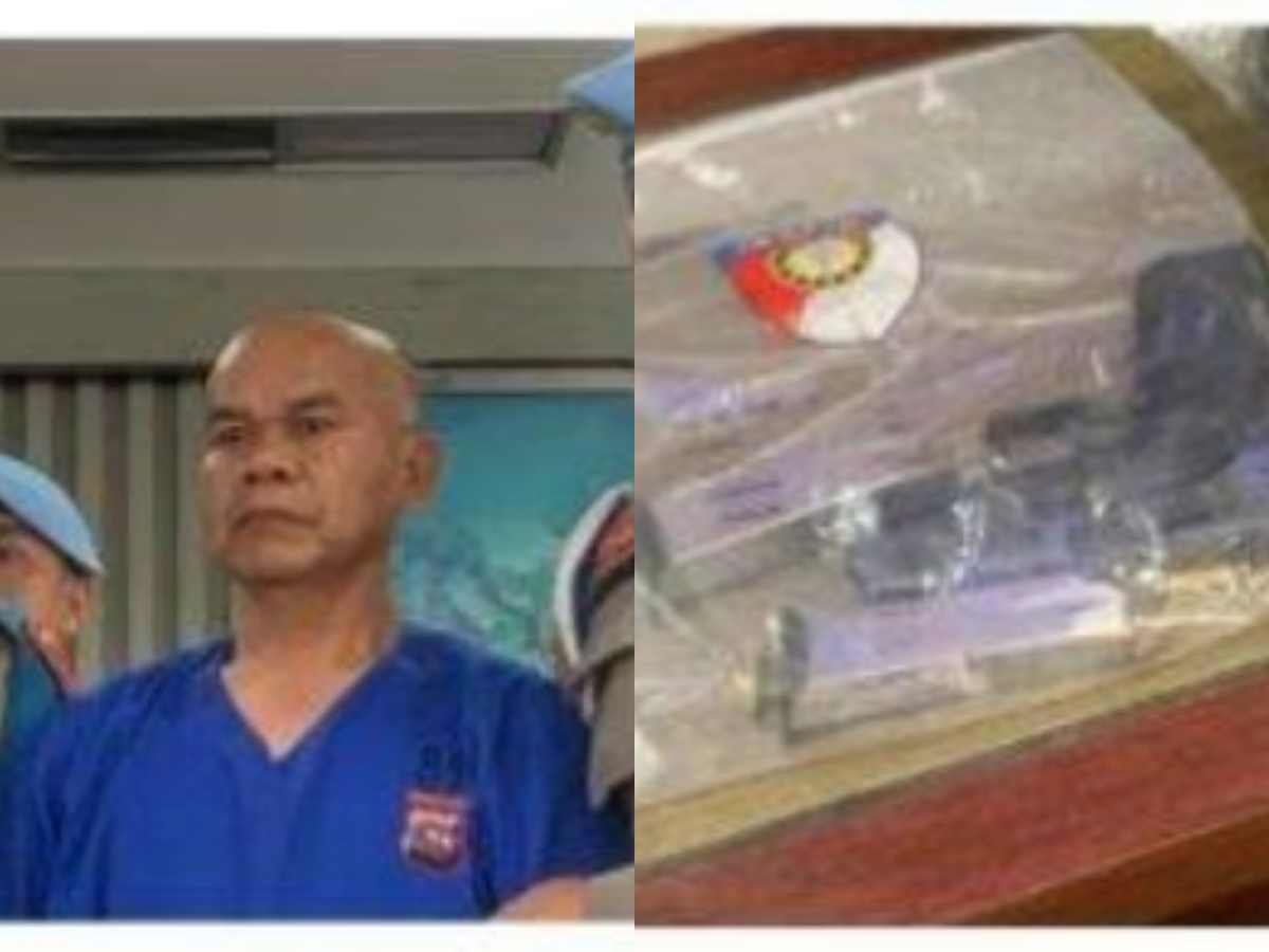 AKP Dadang Iskandar dengan pistol yang digunakannya untuk menembak AKP Ulil Ryanto.