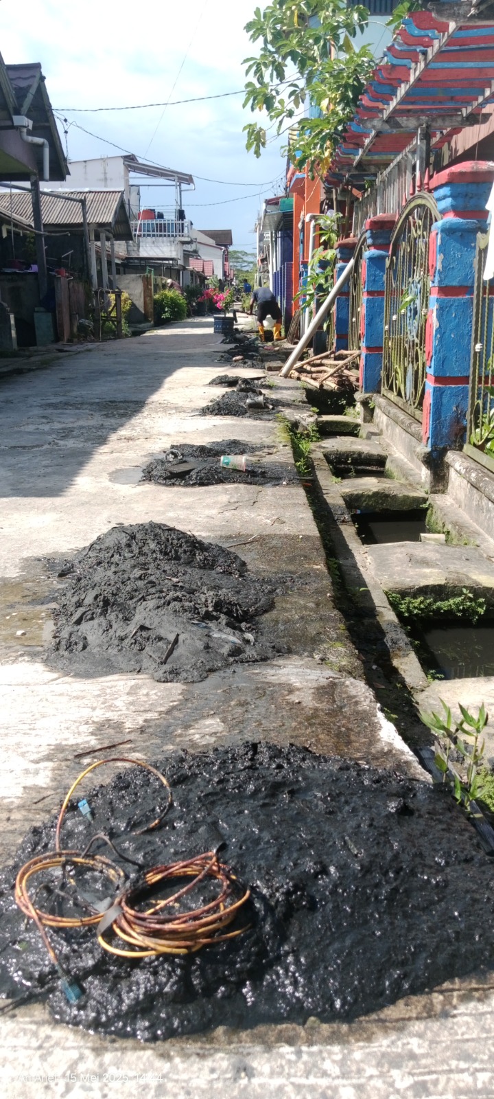 KERJA BAKTI: Sedimentasi yang berhasil diangkat dari lumpur, dan Taufiqurrahman tampak rehat sejenak dari kegiatan kerja bakti.