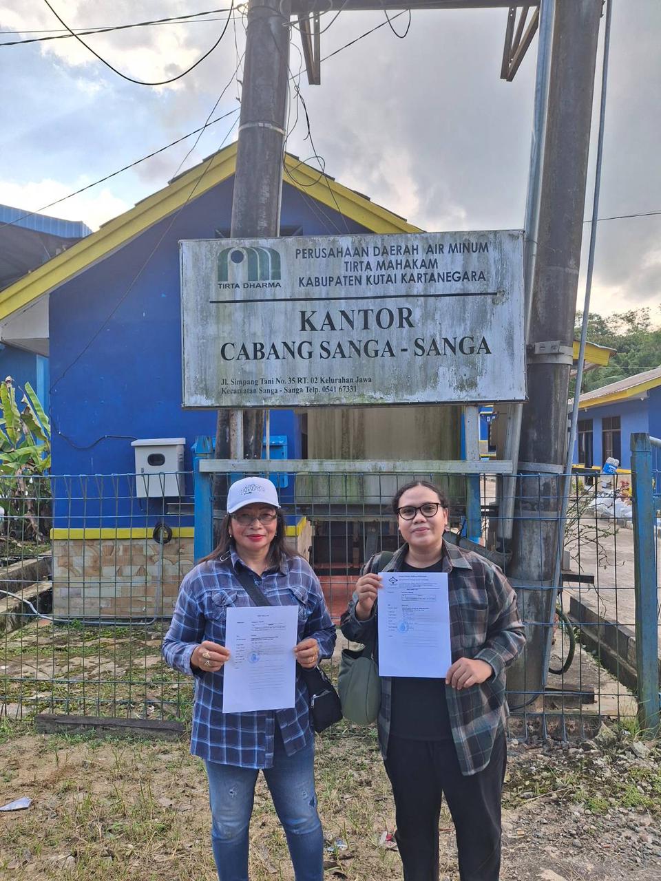 LINGKUNGAN: Dinamisator Jatam Kaltim, Mareta Sari (kanan) bersama warga menunjukkan bukti permohonan informasi hasil uji laboratorium air baku kepada Perumda Tirta Mahakam Sangassanga,
