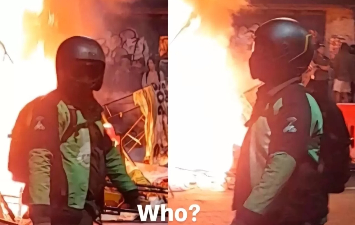 Sosok beratribut ojek online terekam dalam video diduga melempar bom molotov saat pembakaran sisi barat Gedung Negara Grahadi Surabaya. (FOTO: IST)