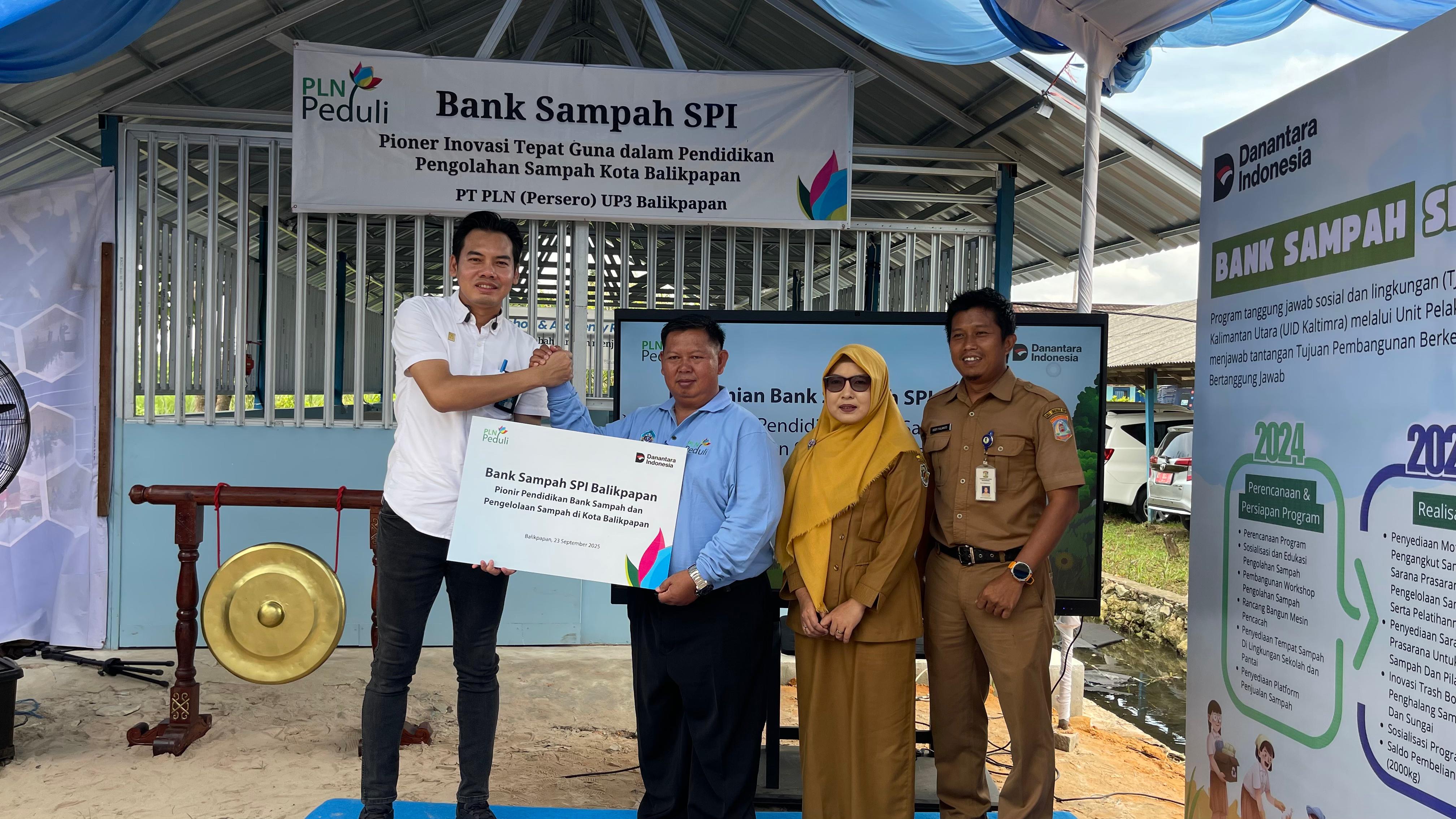 PEDULI LINGKUNGAN: Manager PLN UP3 Balikpapan, Arief Prastyanto (kiri) menyerahkan secara simbolis bantuan Bank Sampah SPI kepada Kepala SMKN 5 Balikpapan, Mohamad Arifin (tiga kanan).