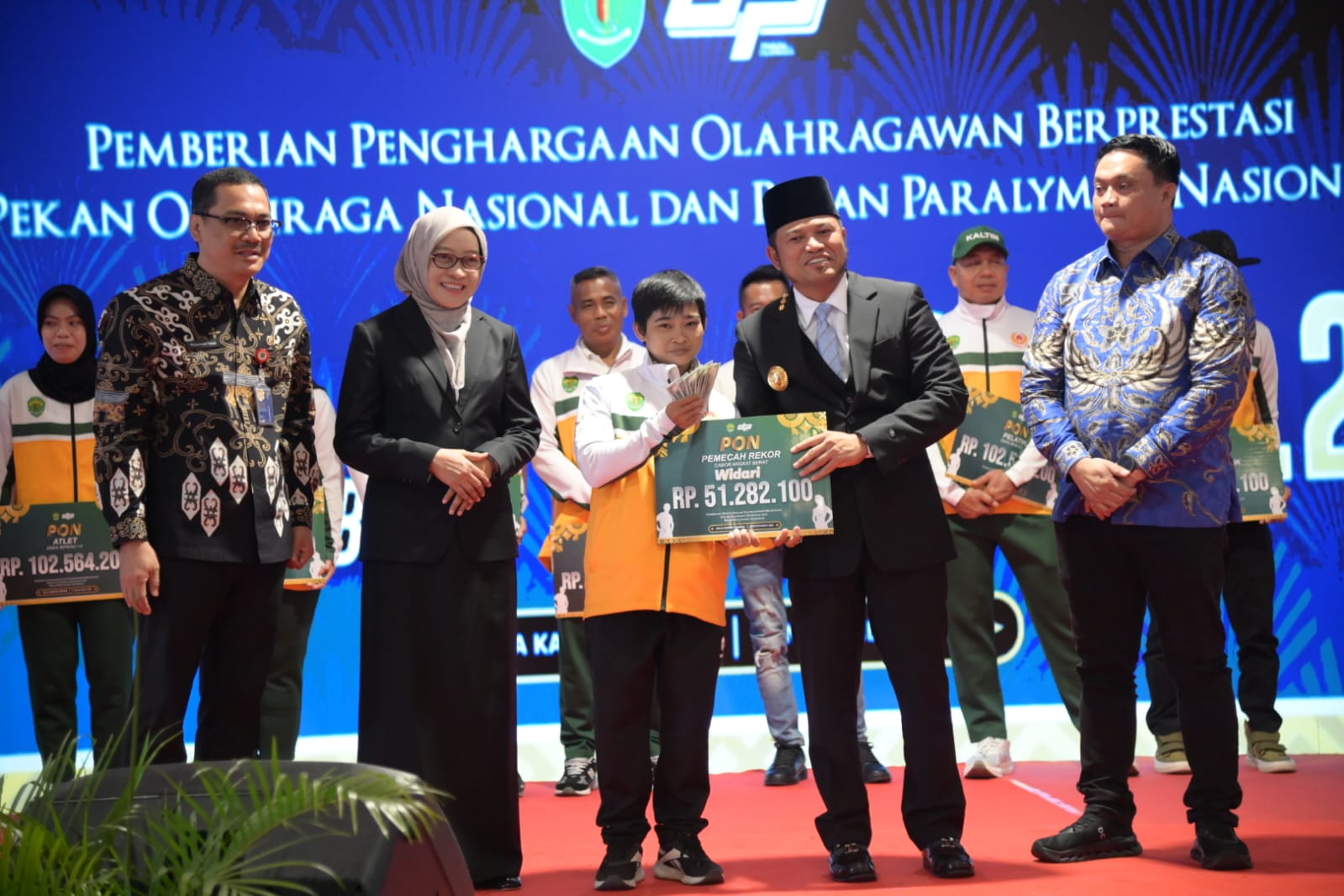 SUDAH CAIR: Widari (tengah) menerima bonus PON secara simbolis dari Gubernur Kaltim Rudy Mas