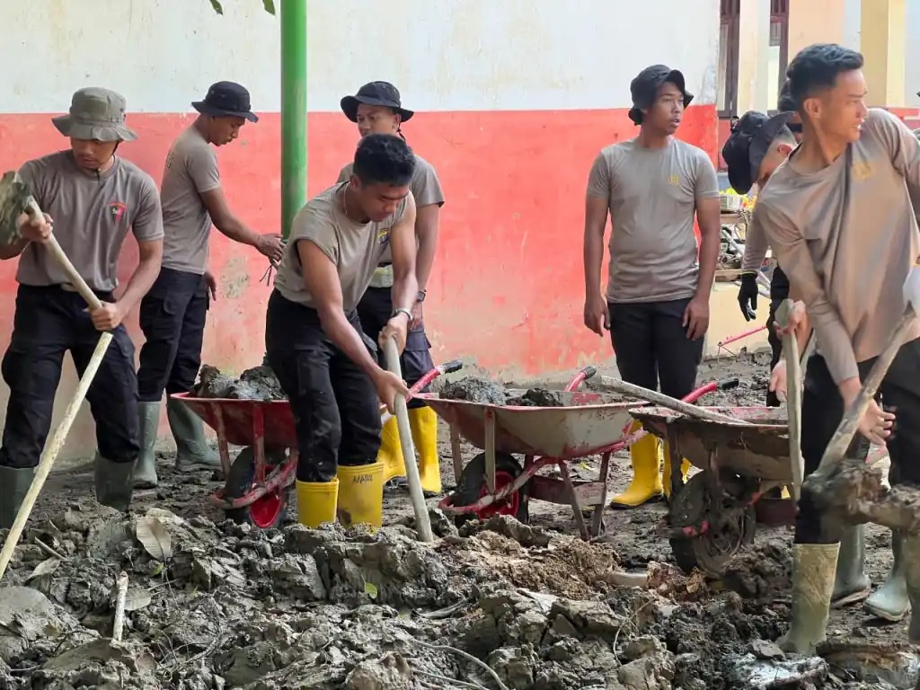 PEMBERSIHAN: Brimob Polda Kaltim melakukan pembersihan fasilitas pendidikan yang terdampak bencana alam di Kabupaten Aceh Utara.
