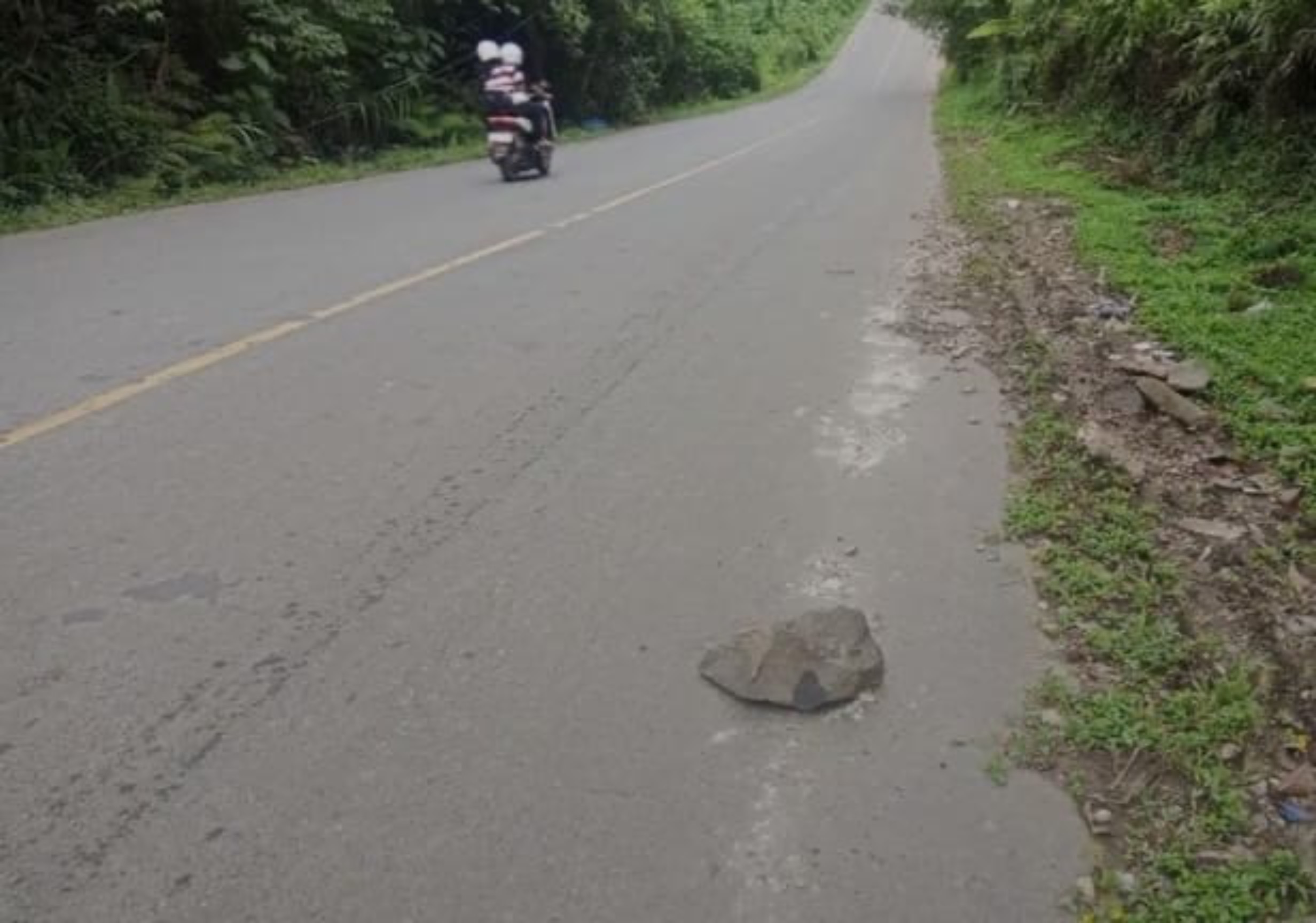 Batu yang digunakan sebagai ganjal kendaraan di tanjakan Gunung Punai dibiarkan di badan jalan dan berpotensi membahayakan pengguna jalan lainnya.