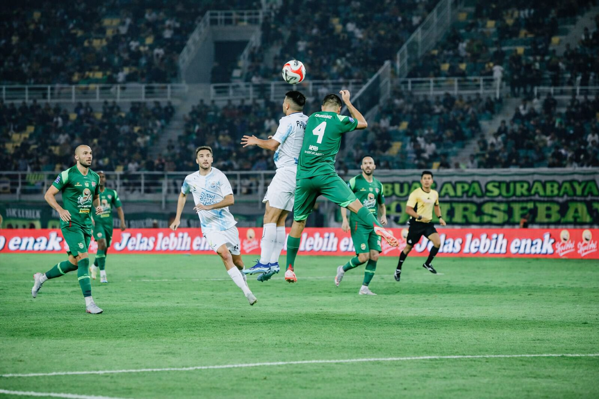 Aksi duel perebutan bola antara pemain PSIM Yogyakarta dan Persebaya Surabaya di Super League 2025/2026.