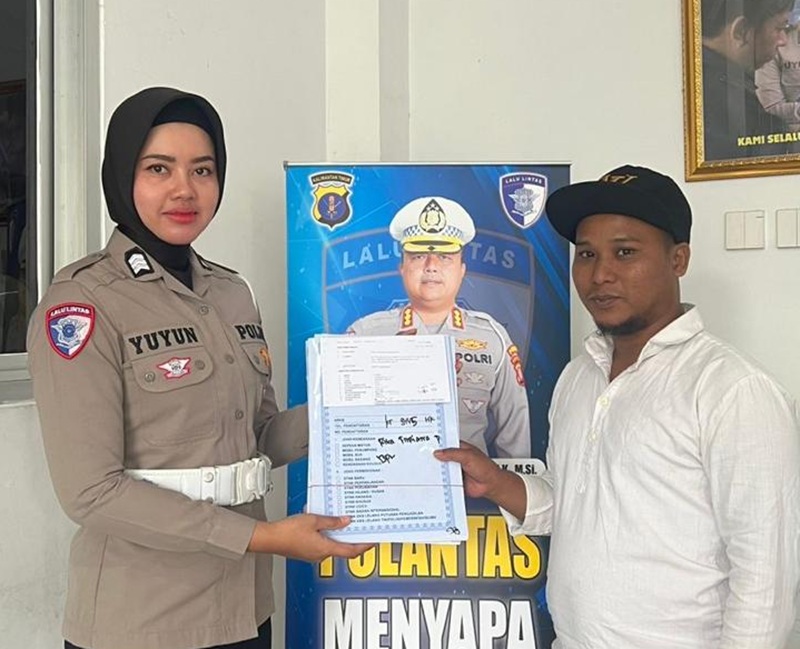 PELAYANAN: Polwan personel Subdit Regident Ditlantas Polda Kaltim berbincang dengan warga yang mengurus BPKP di Samsat Markoni.