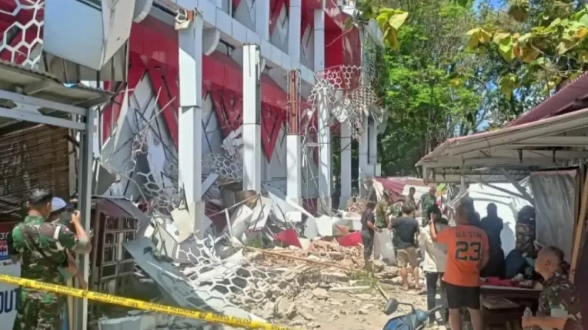 Kondisi bangunan yang rusak akibat gempa magnitudo 7,6 di Manado, Kamis (2/4). Material bangunan runtuh berserakan, sementara warga dan aparat berjaga di sekitar lokasi terdampak. (Foto Jawa Pos Group)