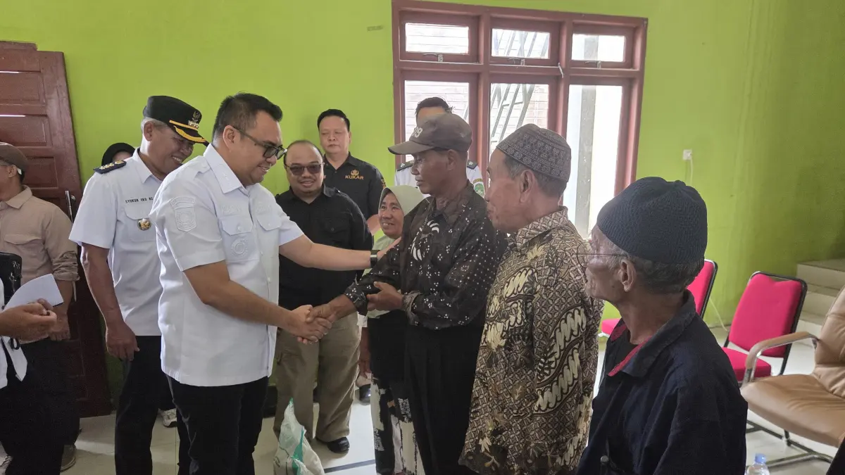 PENOPANG PANGAN: Bupati Kutai Kartanegara, Aulia Rahman Basri, secara simbolis menyerahkan bantuan beras kepada warga terdampak banjir di Desa Rapak Lambur, Rabu (8/4/2026). Sebanyak 1.084 karung beras disalurkan untuk membantu petani yang mengalami gagal panen akibat luapan Sungai Mahakam. (Pemkab Kukar)
