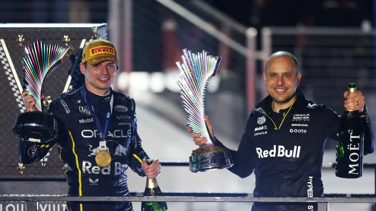 Gianpiero Lambiase (kanan) mendampingi Max Verstappen di podium GP Las Vegas pada 22 November 2025. (PATRICK FALLON/AFP)