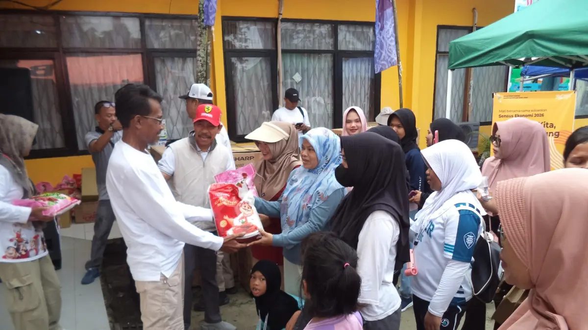 Kepala Disnakertrans PPU, Adriani Amsyar memyerahkan hadiah kepada peserta yang mengikuti jalan santai dengan membawa anak lebih dari dua dalam peringatan May Day 2026. (AHMAD MAKI/KP)