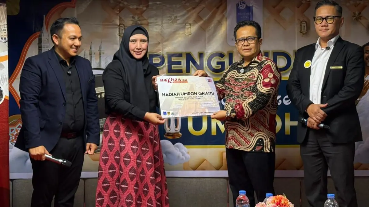 Trisna Putra (dua kanan) memberikan hadiah umrah kepada pelanggan setia.